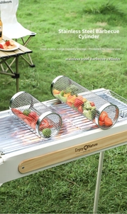Detail of two-piece stainless steel rolling grill baskets with vegetables on a grill
