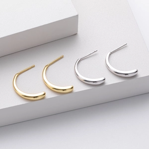 Detail showing high-polish S925 silver C-shape stud earrings in gold and silver finishes