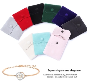 Detailed view of multi-color velvet jewelry pouches with snap button and a rose gold bracelet