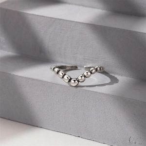 Detailed macro shot of a vintage S925 sterling silver V-shaped beaded open ring design