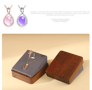 Macro detail of wooden jewelry display stand with velvet slots for necklaces and rings