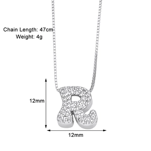 Macro detail of silver initial R pendant with sparkling zircon inlay and 47cm chain length