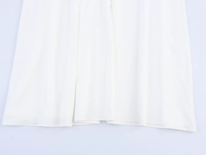 Detailed view of white chiffon dress hem showing fabric texture and fine stitching