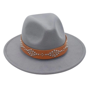 Detail of grey wool felt fedora featuring a brown leather band with silver rivet studs