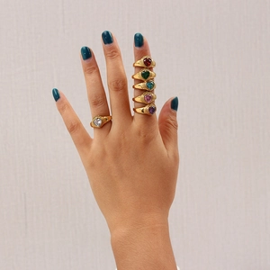 Close-up of gold plated rings featuring heart-shaped colorful zircon stones in various hues
