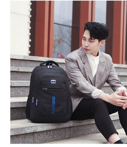 Close-up of a black travel backpack with blue zippers on city stairs in a street style setting