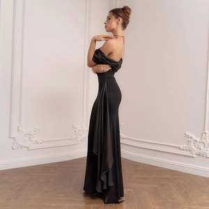Side view of a slim-fit black off-shoulder gown featuring an elegant satin side drape