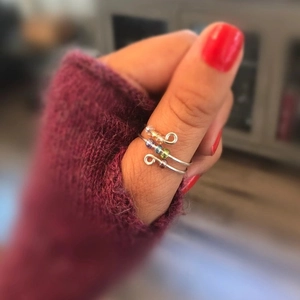 Handmade S925 silver fidget ring with colorful beads worn on woman's thumb
