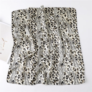 Detailed view of the leopard print satin silk scarf with a smooth and glossy texture