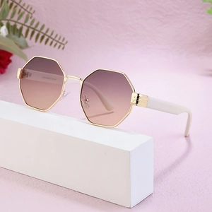 Octagon sunglasses with gold metal frame and gradient brown lenses on white base