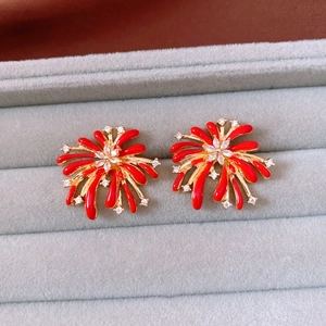 Macro shot of vintage red firework stud earrings with gold plating and cubic zirconia