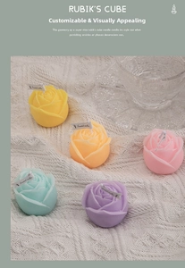 Detail of five rose-shaped scented candles in macaron colors on white knit fabric