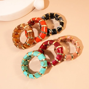 Set of acrylic geometric marbled bangles with golden metal beads in various colors