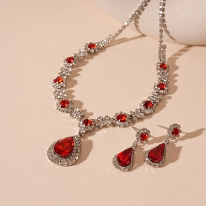 Detail view of vintage luxury water drop jewelry set with red teardrop stones and rhinestones