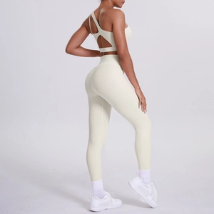 Detail of off-white one-shoulder sports bra and high-waisted yoga leggings set