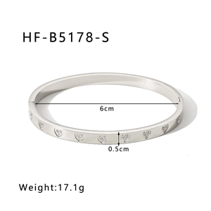 Detailed view of silver heart-shaped engraved bangle with 6cm inner diameter and 0.5cm width