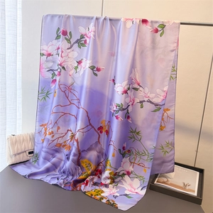 Detailed texture of purple gradient faux silk scarf with elegant floral magnolia print