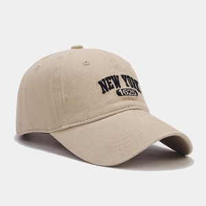Vintage beige cotton baseball cap with black NEW YORK 1625 embroidery on white background