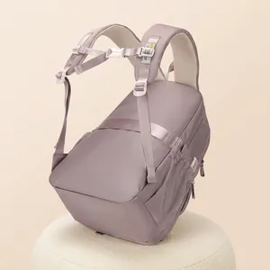 Detail of padded shoulder straps and suitcase luggage strap on purple school backpack