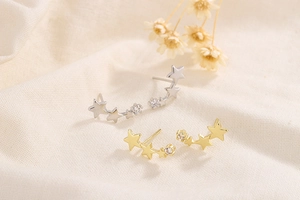 Detailed view of 925 sterling silver ear climbers with triple star studs in gold and silver