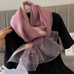 Pink silk scarf detail featuring beaded pearls and gold embroidery on mesh fabric edges