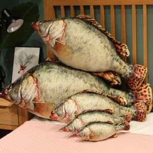 Detailed view of 3D realistic fish plush pillows in five sizes on a cozy bedroom bed