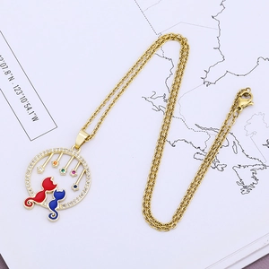 Detail of gold cat pendant with colorful stars and enamel finish on O-chain necklace