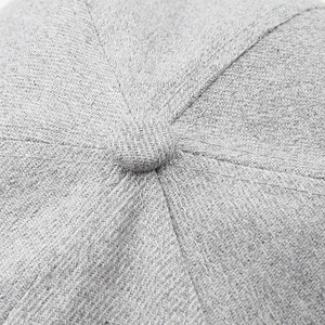 Close-up of the grey baseball cap top showing detailed stitching and fabric texture