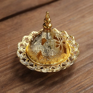 Golden Middle Eastern style hollow incense burner with intricate floral patterns