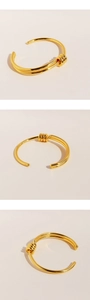 Detailed views of gold-plated twisted rope knot cuff bracelet with smooth metallic finish