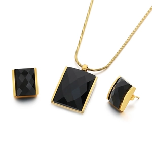 Golden necklace and earrings set featuring black rectangular faceted glass stones