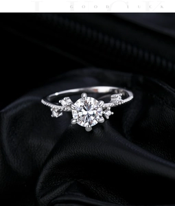 Detailed close-up of a 1-carat moissanite ring with a six-prong flower setting on leather
