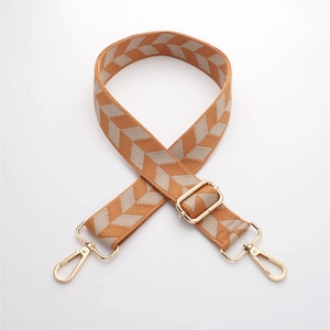 Close-up of orange and beige chevron woven strap with adjustable gold hardware