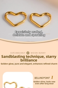 Detail of golden heart-shaped hoop earrings featuring a sandblasted and polished texture