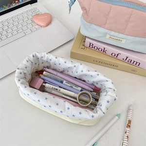 Detailed close-up of quilted aesthetic pencil case featuring blue star pattern and zipper