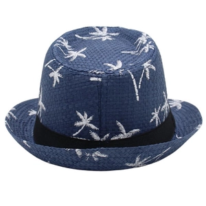 Detail of navy woven beach hat with white palm tree prints and black ribbon trim