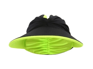 Close-up of dual-color black and neon green sun visor with wide brim and soft top fabric