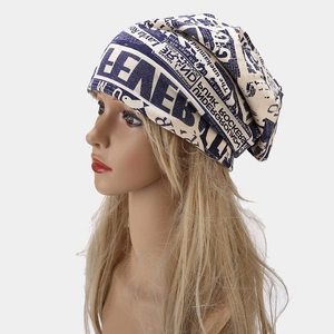 Retro street style beanie with punk rock graphics and navy blue lettering on cream knit