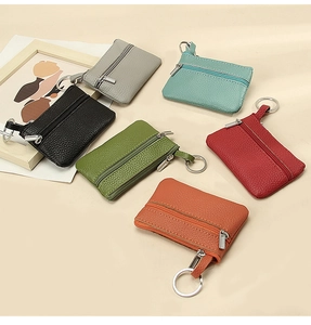 Detail view of colorful lychee texture leather coin purses with metal zippers and keyrings