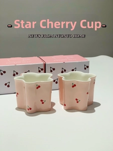Detailed view of pink star-shaped ceramic cherry mugs and sweet gift packaging box