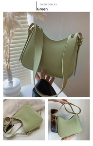 Detail of sage green crossbody bag with textured leather and gold hardware accents