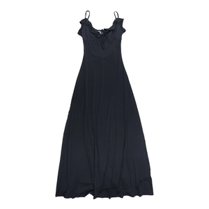 Detail of black evening dress featuring ruffled neckline and spaghetti strap ties