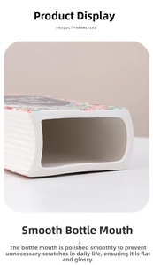 Close-up of smooth, rounded ceramic book vase rim with red floral pattern accents