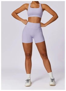 Detailed view of lavender yoga set featuring high-waist shorts and racerback sports bra