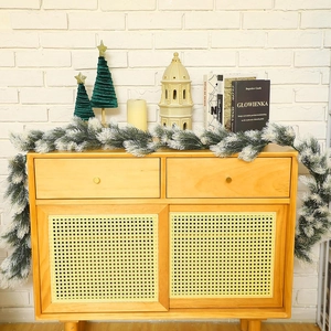 Detail of 180cm flocked Christmas pine garland with snow effect on wooden cabinet