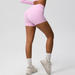 Detailed back view of pink high-waisted yoga shorts with body-shaping push-up effect