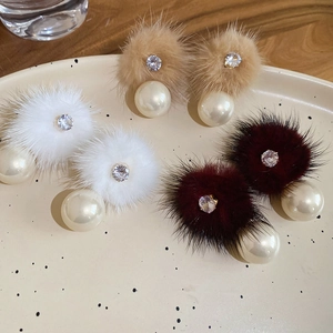 Detailed close-up of zircon pearl pom-pom earrings in white, camel, and burgundy shades