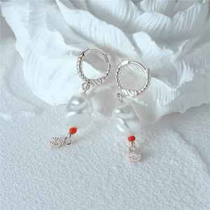 Detail of s925 silver twist hoop earrings with baroque pearl and red accent bead