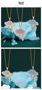 Detail of cloud pendants in pink, blue, and white with crystals and gold water droplets