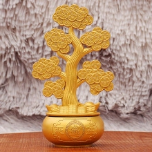 Golden money tree figurine with coin branches on a traditional brass basin base